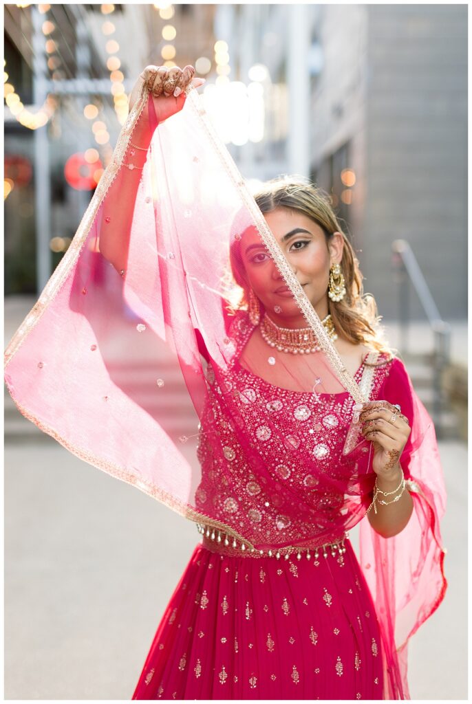 Close-up of a senior in traditional lehenga outfit with texture and pink and gold accessories