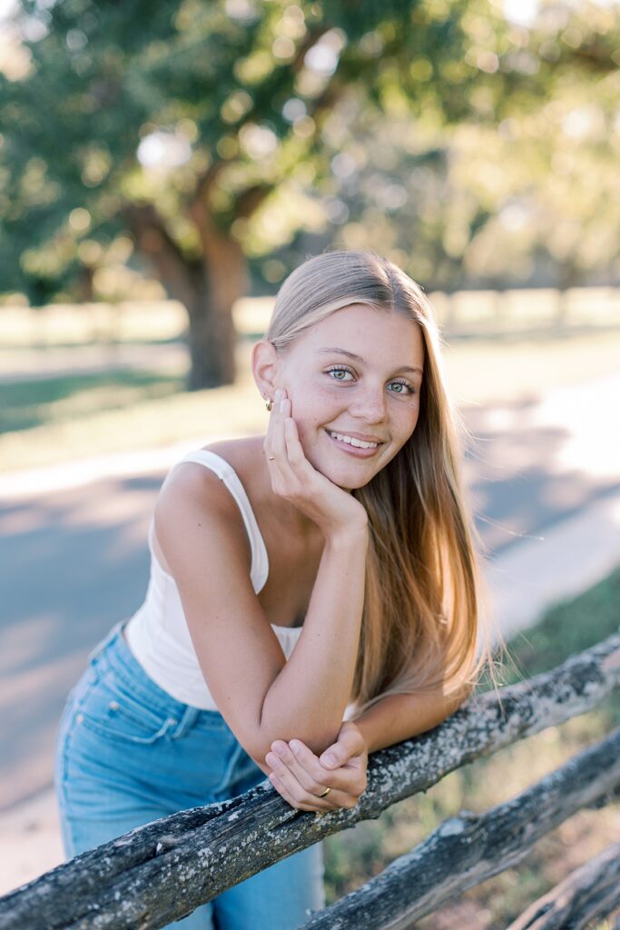 Natural light close-up portrait of a Malibu senior girl with wind-blown hair and a soft smile