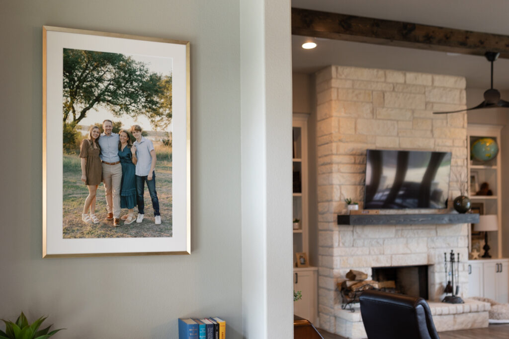 Framed family portrait with high schoolers displayed in a home entryway, showcasing how photography & interior design create a personal, welcoming space