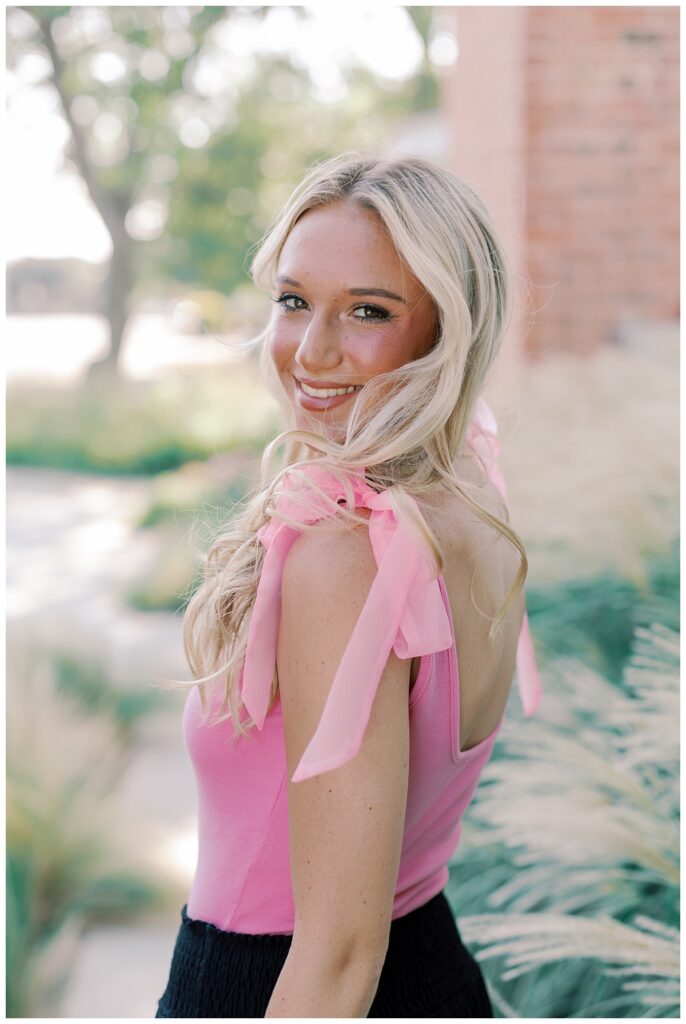 Senior portrait makeup look in soft light, with a confident pose