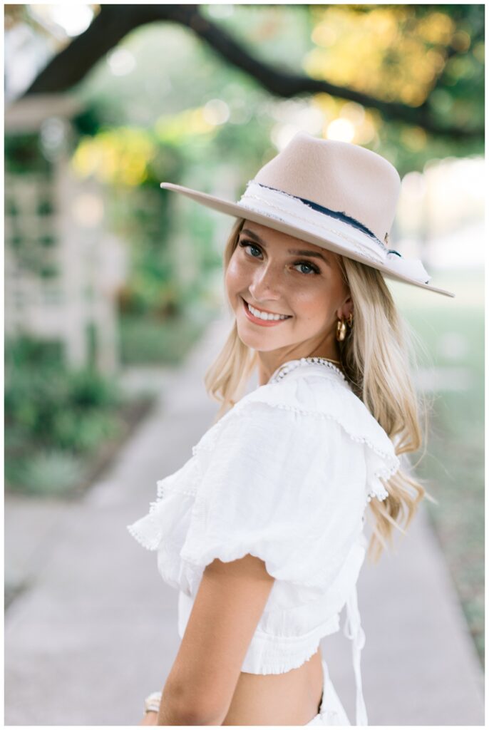 Close-up of a senior outfit with texture and accessories with hat and white dress