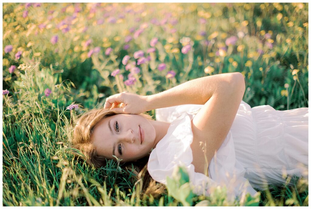 Senior photo in Southern California wildflower field with natural light