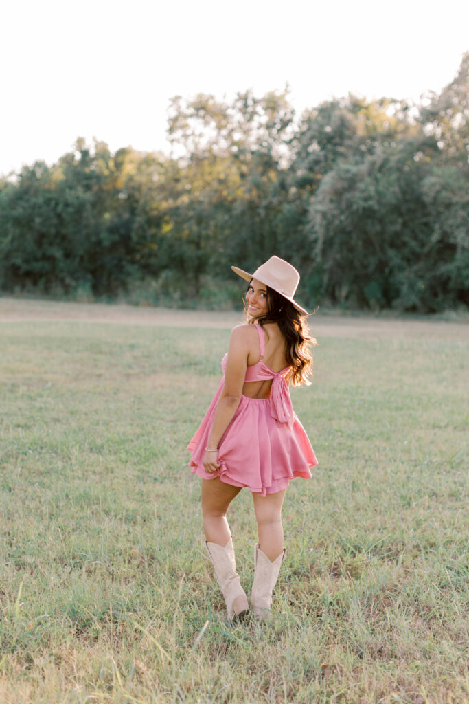 Senior girl in cowgirl boots posing outdoors – modern western senior photo ideas for Malibu and SoCal.