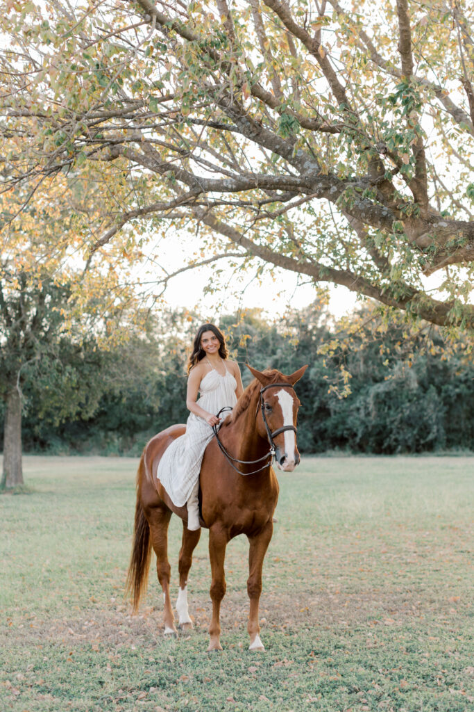 Senior confidently riding horse in front view – bold and grounded portrait from Southern California session.
