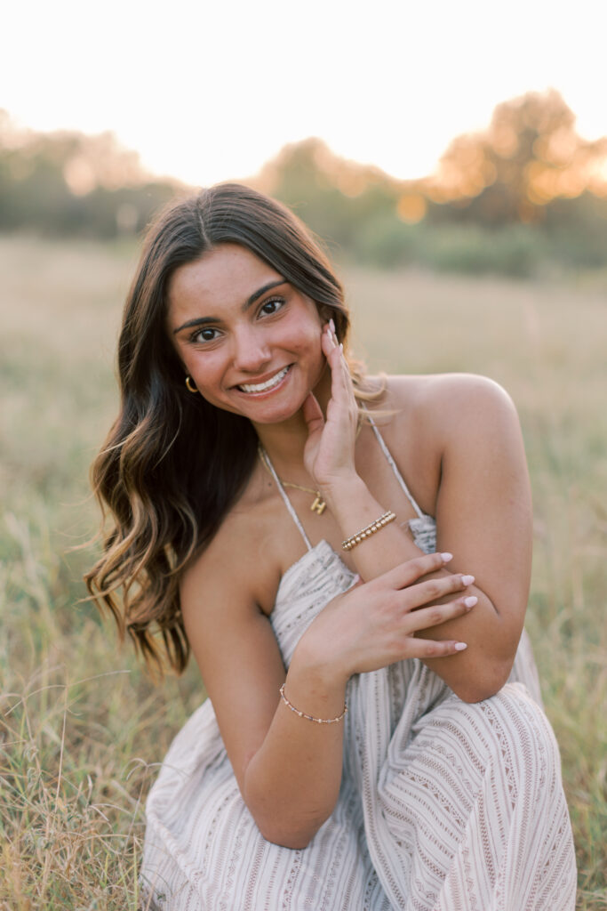 Senior close-up smiling with golden light behind in Southern California