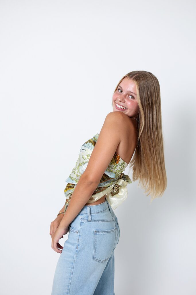 Close-up senior portrait of with a big smile and long straight hair, in Southern California