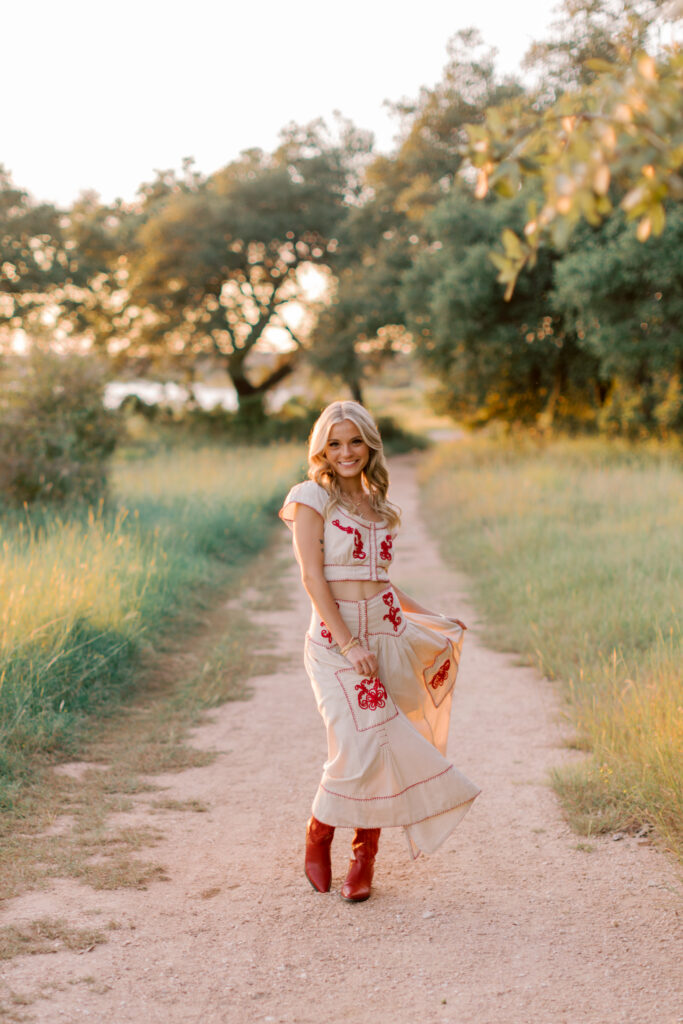 Malibu senior photographer captures girl in red and cream outfit at golden hour