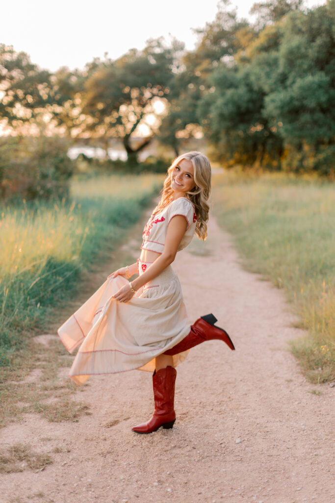 Senior session in Malibu with cowgirl boots and natural outdoor path