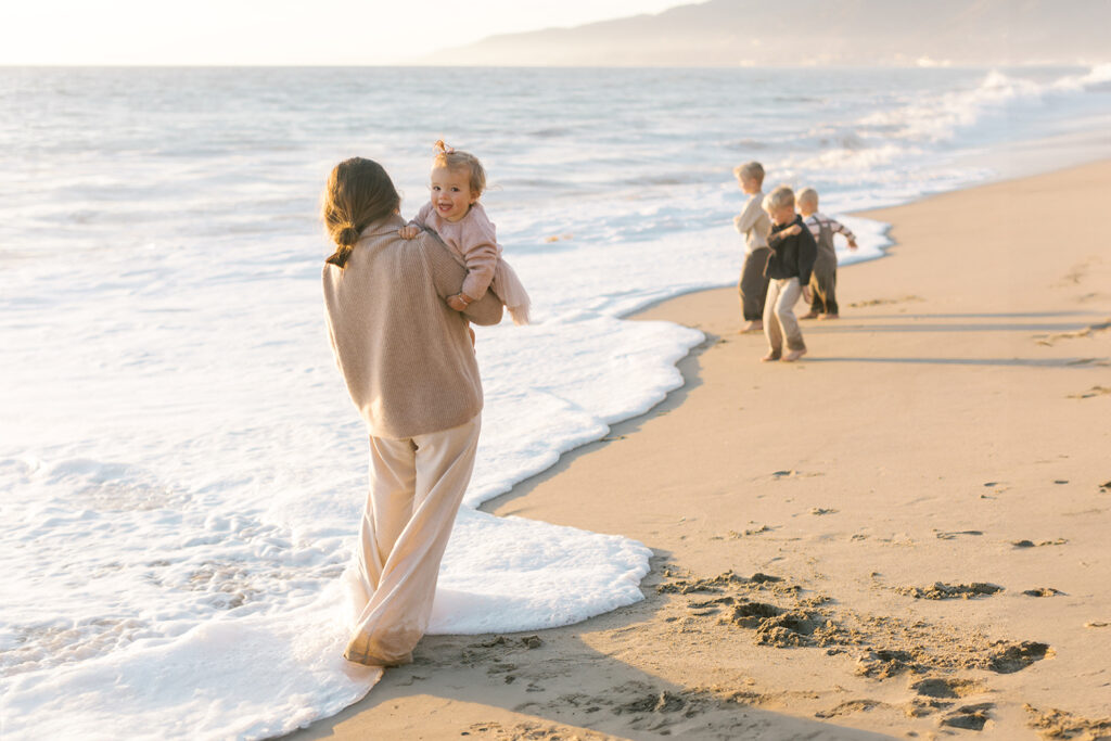 Family playing on Westward beach at sunset by Malibu photographer.