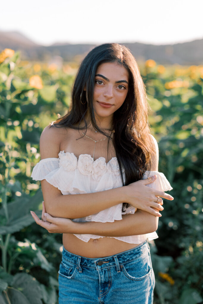 Natural senior portrait in a sunflower field near Westlake Village photographed by a Westlake senior photographer