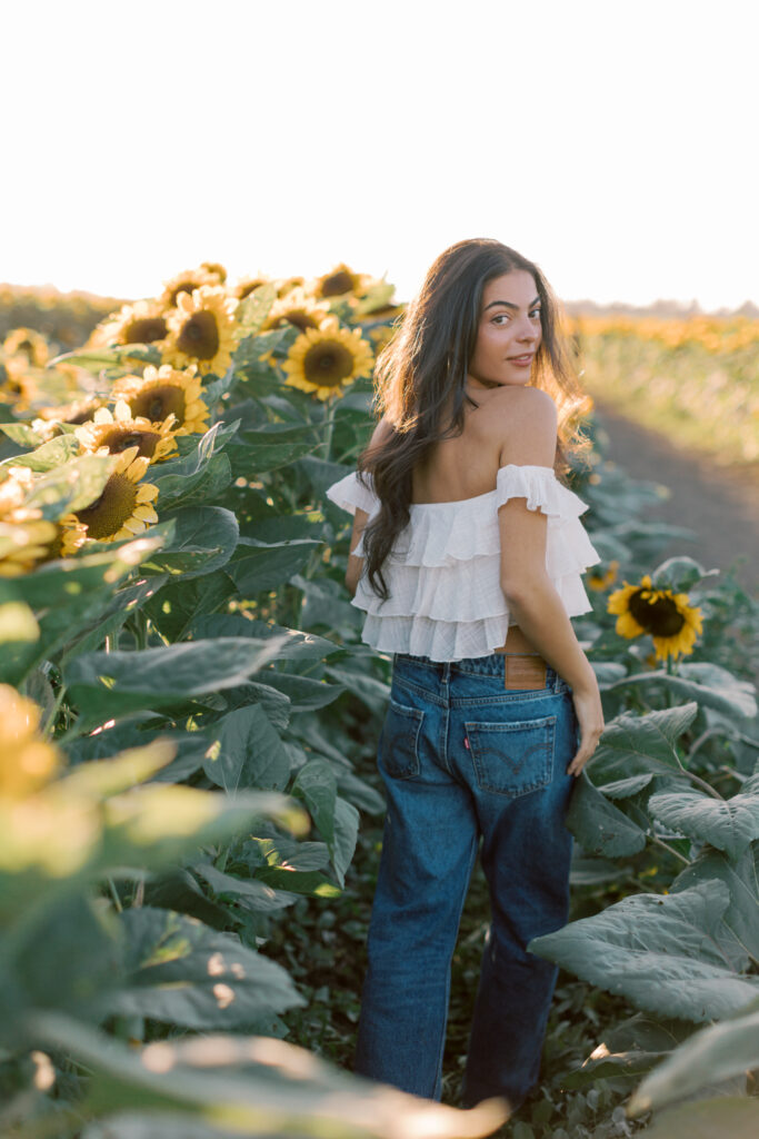 Westlake High School senior walking through sunflowers at Conejo Family Farms near Thousand Oaks