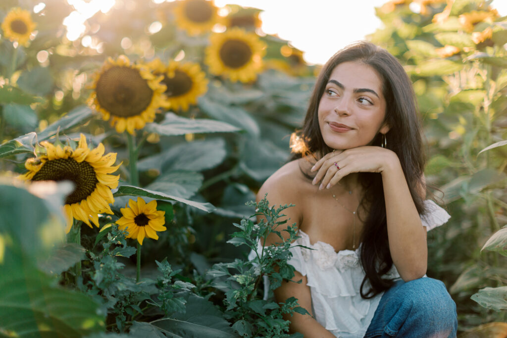 Close-up senior photo framed by sunflowers near Westlake Village photographed by a Calabasas senior photographer