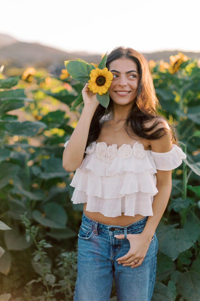 Senior holding a sunflower during an outdoor senior session near Westlake Village California