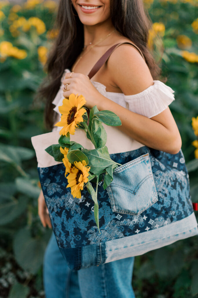 Detail photo of handmade denim patchwork tote bag with sunflowers during senior session near Westlake Village