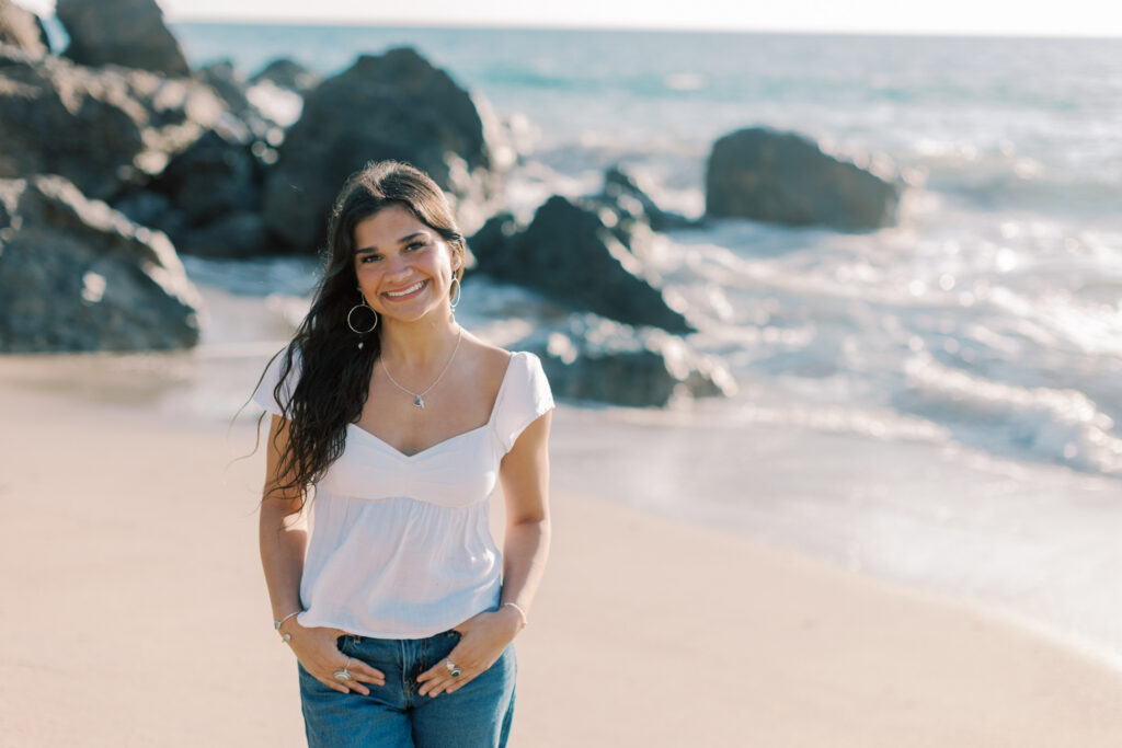 high school senior walking along the shoreline at Point Dume Malibu with ocean waves, relaxed candid senior photos Southern California photographer