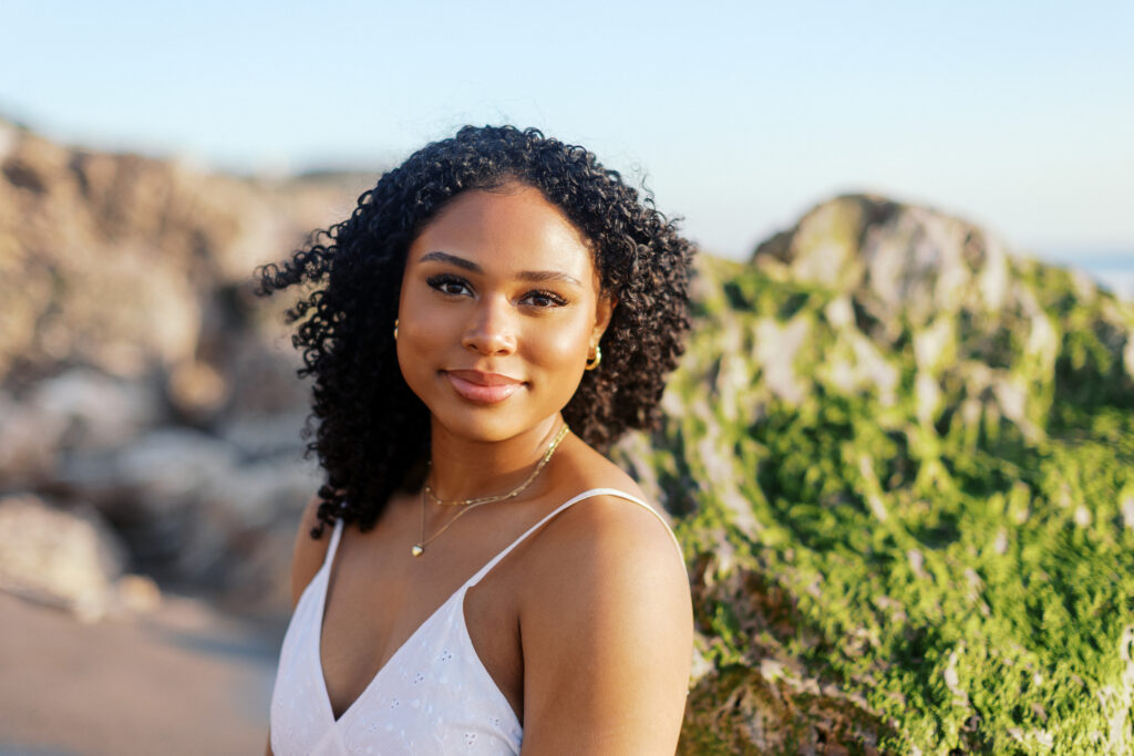 Oaks Christian senior portrait at Westward Beach Malibu with cliffs and shoreline in the background