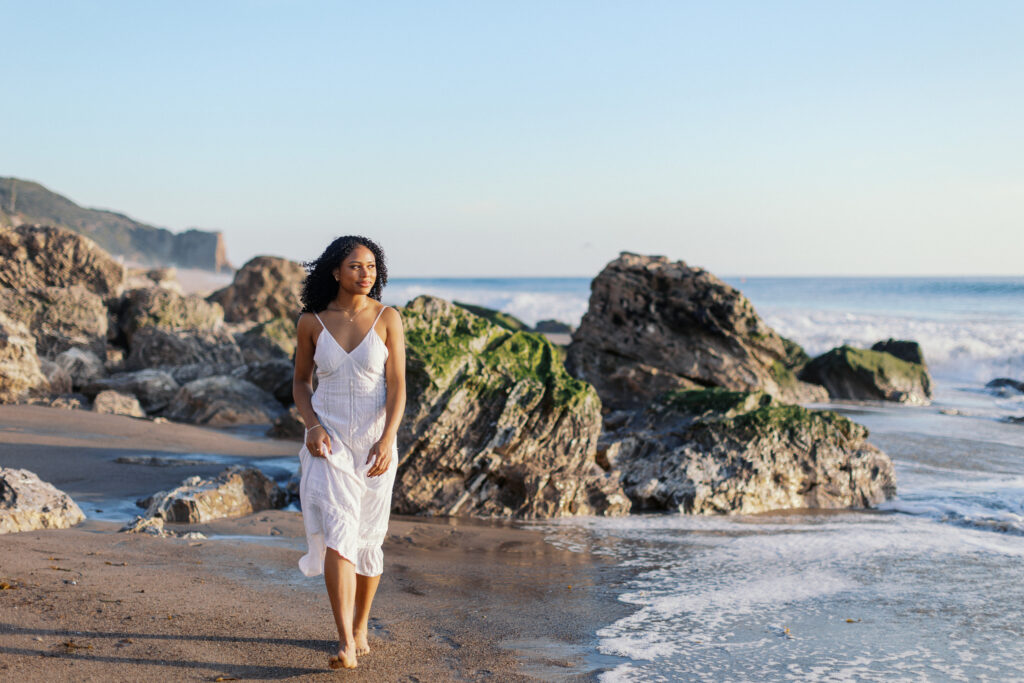 Oaks Christian senior photos at Westward Beach Malibu featuring rocky coastline and ocean backdrop