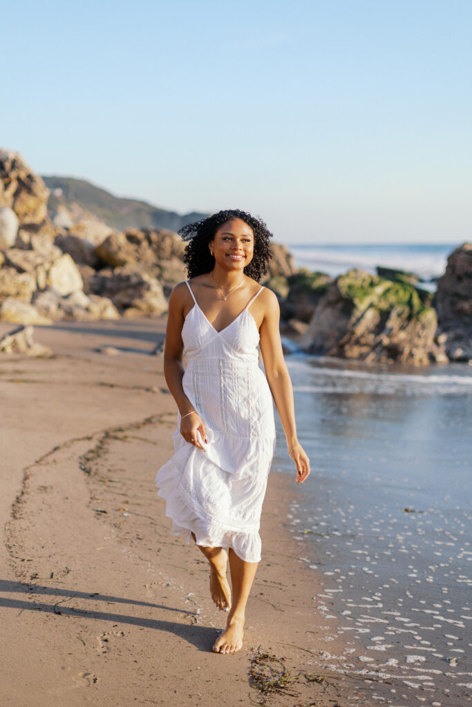 Oaks Christian High School senior portrait at Westward Beach Malibu with coastal rocks and natural beach light