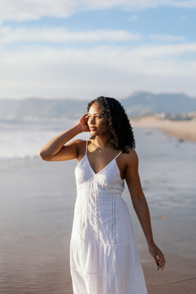 Oaks Christian High School senior at Westward Beach Malibu during golden hour with soft coastal light