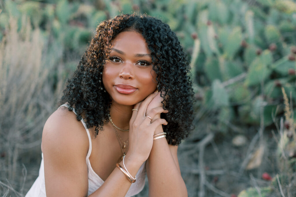 Thousand Oaks senior portrait in a cactus field with soft natural light and relaxed posing in Southern California