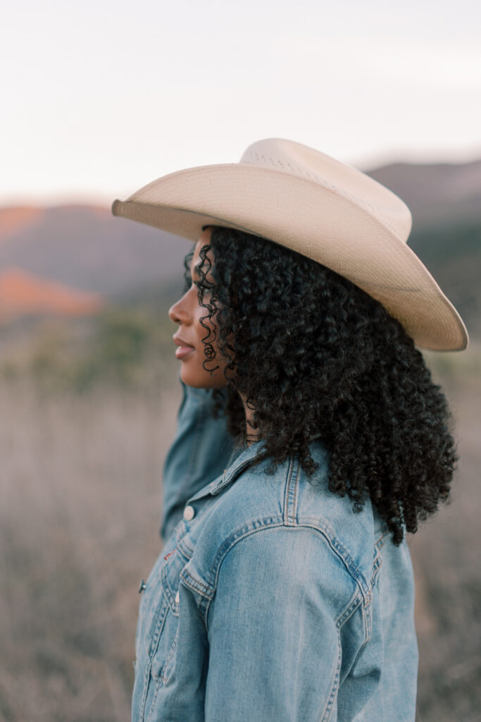 Side profile of a Thousand Oaks High School senior wearing a cowboy hat in the Santa Monica Mountains during golden hour